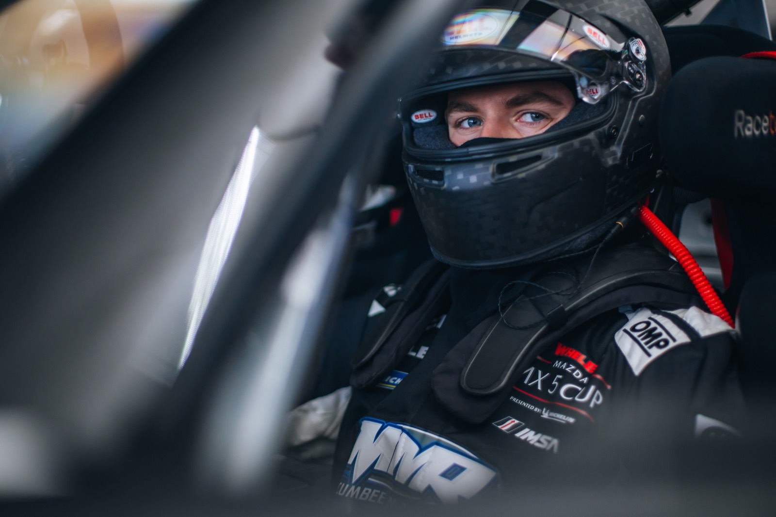 Ren in his helmet, strapped into the race car
