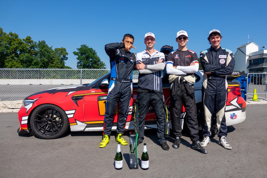Ren and his teammates with the car and champagne