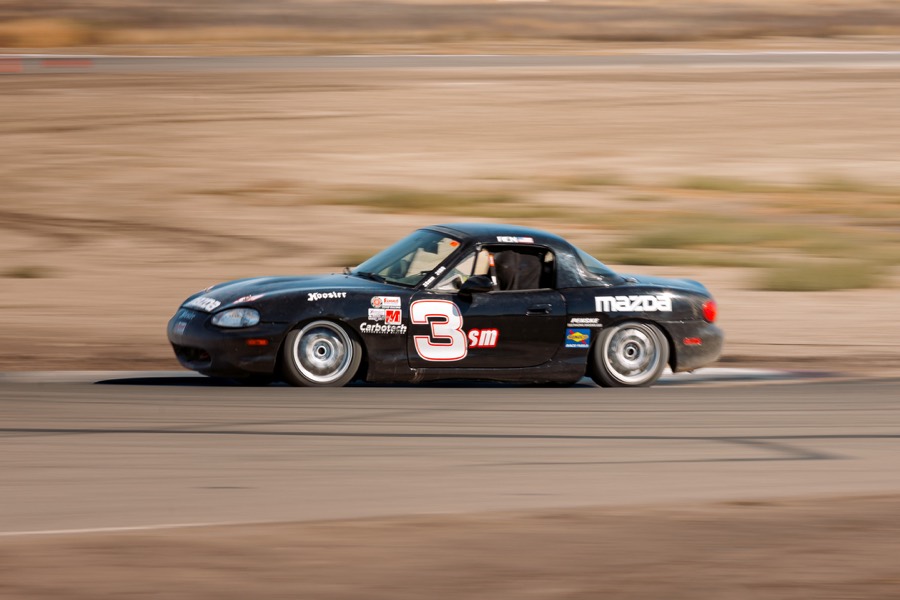 Ren's black number 3 Spec Miata at speed