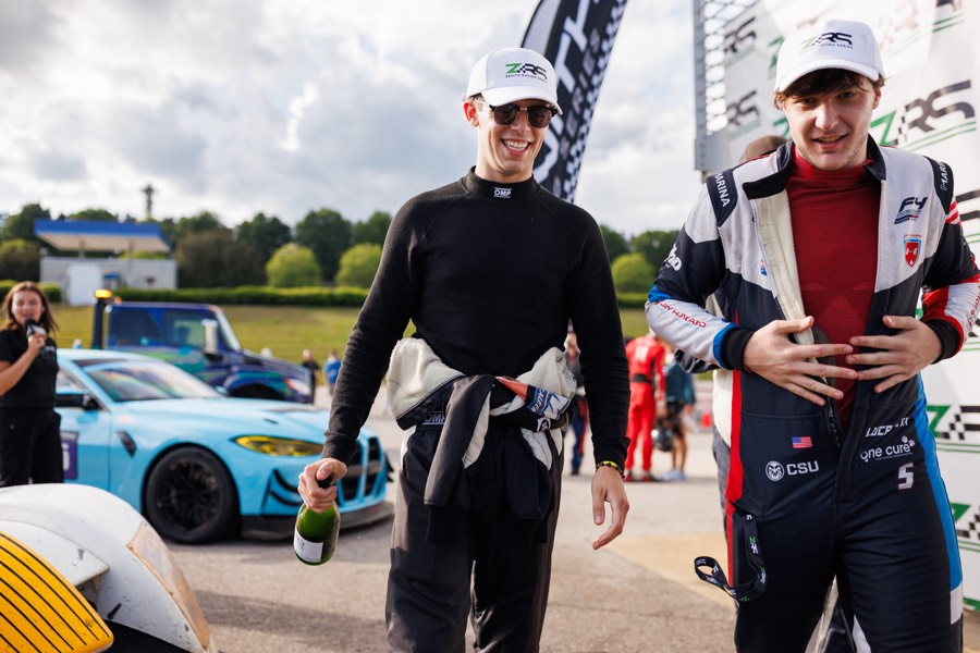 Ren walking back from the podium with champagne