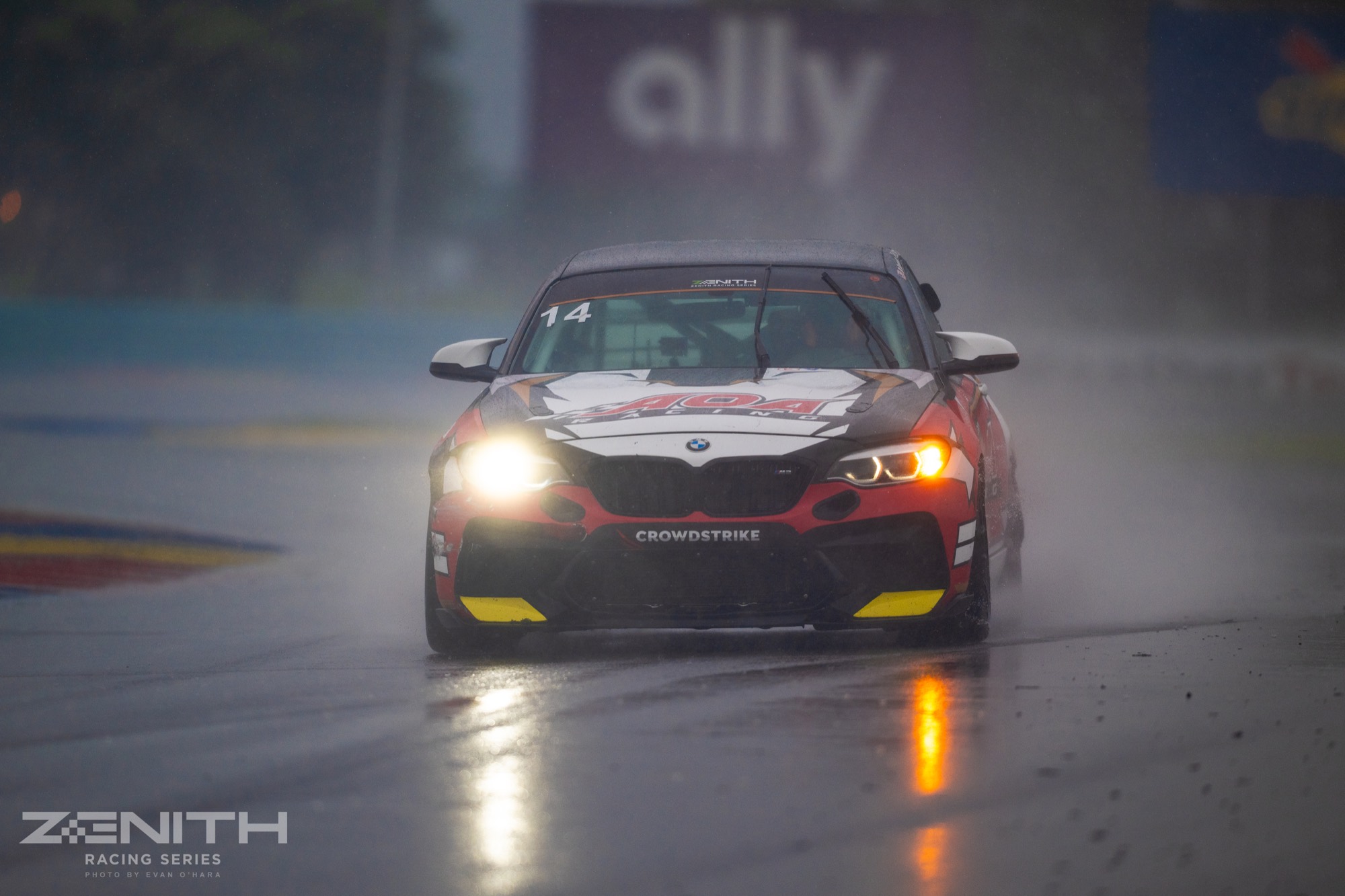 Ren's BMW M2 in the rain, headlights on